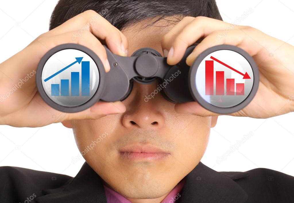 Businessman search stock through binoculars 