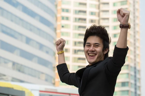 Asian businessman hand up after successful — Stock Photo, Image