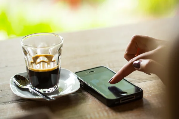 Coffee lifestyle ,a woman touching her smartphone for check information.