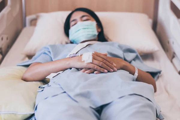 Close up of hand patient women during sleeping on sick bed at the hospital