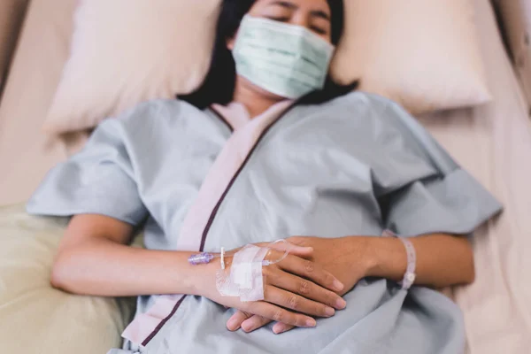 Close up of hands patient woman during sleeping on sickbed at the hospital