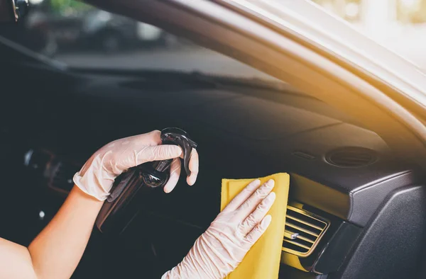 Hands spraying and using cloth cleaning car inside dashboard,Safety and protect infection during covid-19 virus pandemic situation