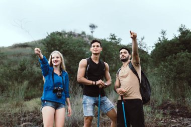 Group of happy traveler friends looking beautiful view together at nature,Enjoying backpacking concept