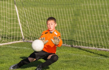 boy goalkeeper defends  clipart