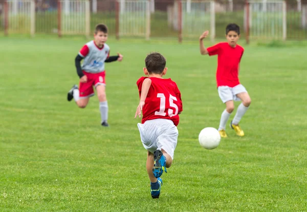 Boys kicking ball — Stock Photo, Image