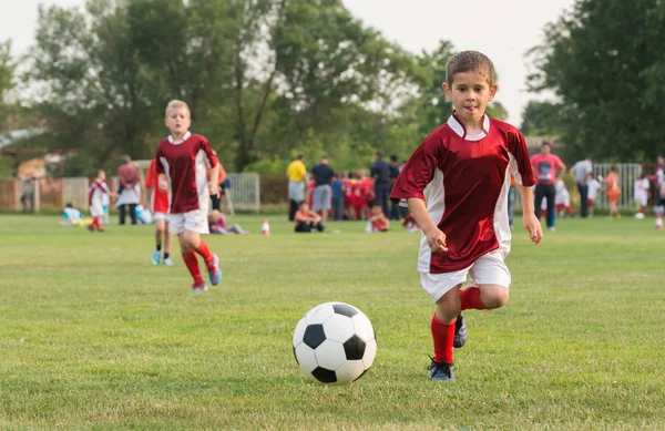 Boys kicking ball — Stock Photo, Image