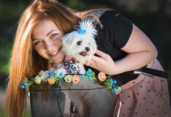 Pretty girl with bicycle and Maltese dog — Stock Photo, Image