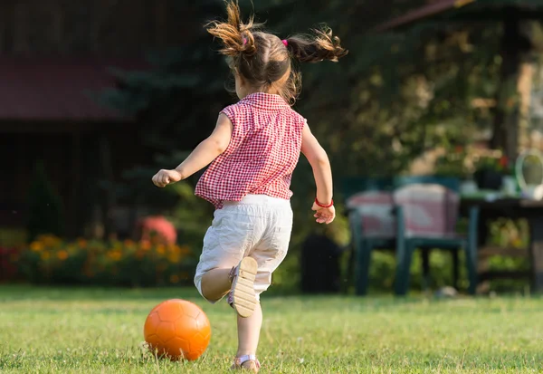 Mädchen kickt Ball — Stockfoto