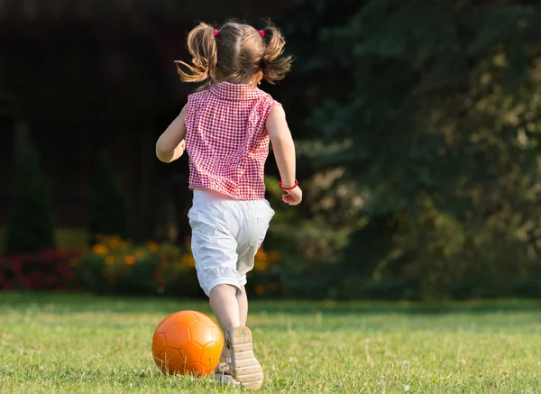 Girl kicking ball — Stock Photo, Image