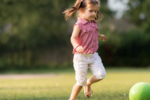 Girl kicking ball — Stock Photo, Image
