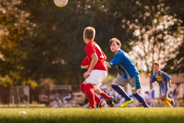 Boys playing football soccer game on sports field — Stock Photo, Image