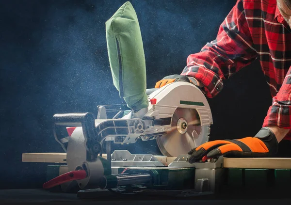 Closeup Young Man Sawing Lumber Sliding Compound Miter Saw Indoors — Stockfoto