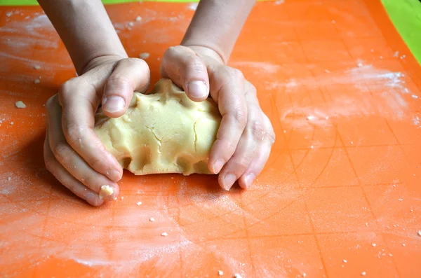 Process of making a dough from farina and butter on orange silicone pad — Stock Photo, Image