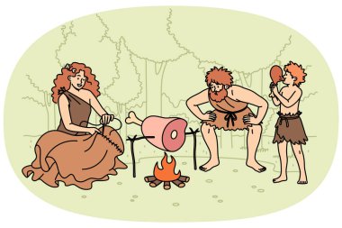 İlkel insanların ailesi ateşin etrafında durur, akşam yemeği için et kızartırlar ya da elbise dikerler. Farklı yaşlarda, taş devrinde paçavralar içinde yaşayan bir grup ilkel insan.
