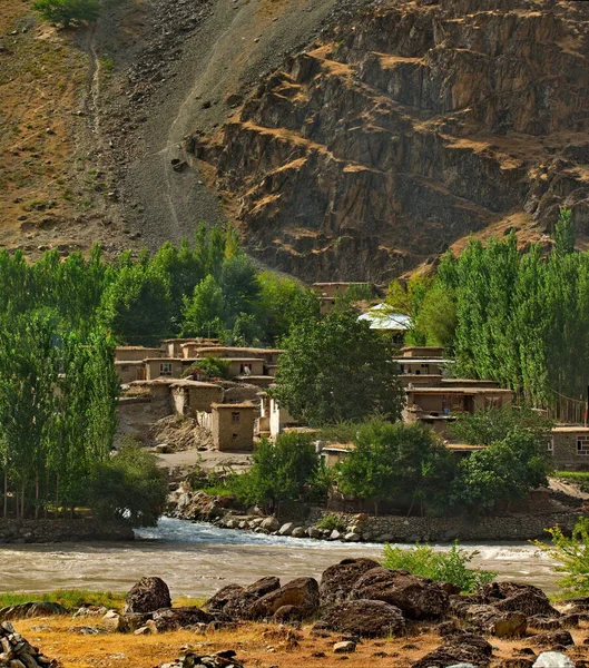 Central Asia. Afghanistan. Huts made of clay and stone in a mountain village on the left coast of the border river Panj. — Stock Image Central Asia Afghanistan Huts Made Clay Stone Mountain Village Left Royalty Free Stock Photos