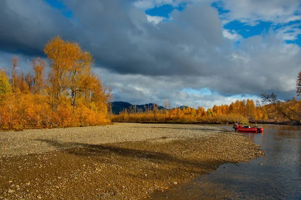 Russia. Far East, Magadan region. Picturesque autumn fishing from a boat on the tributaries of the Kolyma River.
