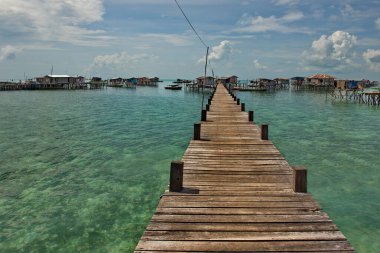 Semporna. Malaysia. December 01, 2018. Wooden walkways in a sea gypsy village on one of the many reef islands. Only on them you can get to the residential buildings of the village.