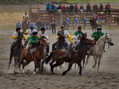 Kupchegen. - Rusya. 14 Mayıs 2021. Altai Ulusal Binicilik Oyunu Kok-Boru. Oyuncuların at üstünde spor aletleri için 35 kg ağırlığında bir keçi leşi (ulah) şeklinde dövüştüğü an.