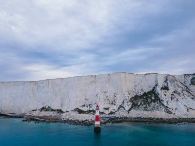 Aerial Drone Landscape photo of a Beachy Head Lighthouse and chalk cliffs at colorful sunrise  with low tide in England, near Eastbourne