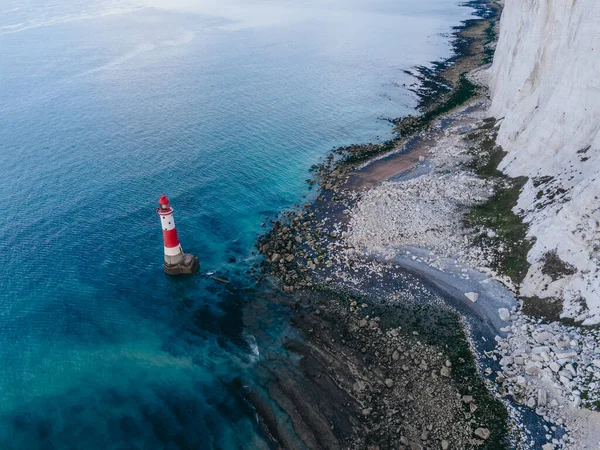 Aerial Drone Landscape photo of a Beachy Head Lighthouse and chalk cliffs at colorful sunrise  with low tide in England, near Eastbourne