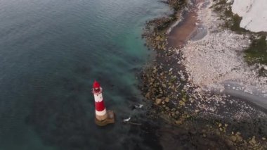 Bir Beachy Head Deniz feneri ve tebeşir kayalıklarının Eastbourne yakınlarında, İngiltere 'de alçak gelgitle birlikte renkli gündoğumunda çekilmiş peyzaj hava aracı görüntüleri.