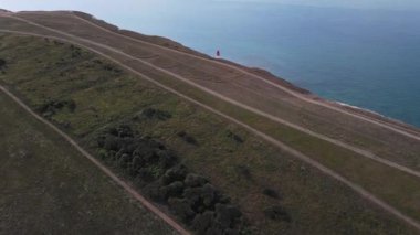 Bir Beachy Head Deniz feneri ve tebeşir kayalıklarının Eastbourne yakınlarında, İngiltere 'de alçak gelgitle birlikte renkli gündoğumunda çekilmiş peyzaj hava aracı görüntüleri.