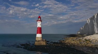 Bir Beachy Head Deniz feneri ve tebeşir kayalıklarının Eastbourne yakınlarında, İngiltere 'de alçak gelgitle birlikte renkli gündoğumunda çekilmiş peyzaj hava aracı görüntüleri.