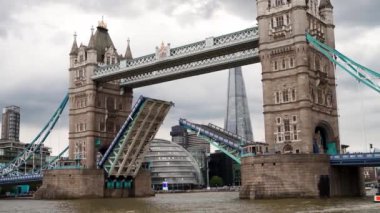 Thames Nehri üzerindeki Askı Kule Köprüsü açılırken bulutlu yaz gününde gemiler batıyor.
