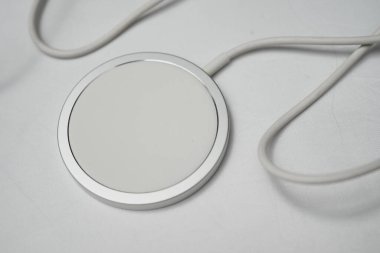 Londra, Birleşik Krallık 2025.10.16 Hakiki Apple MagSafe kablosuz şarj modeli A2140 USB-C konnektörü beyaz arka plana yerleştirilmiş. 