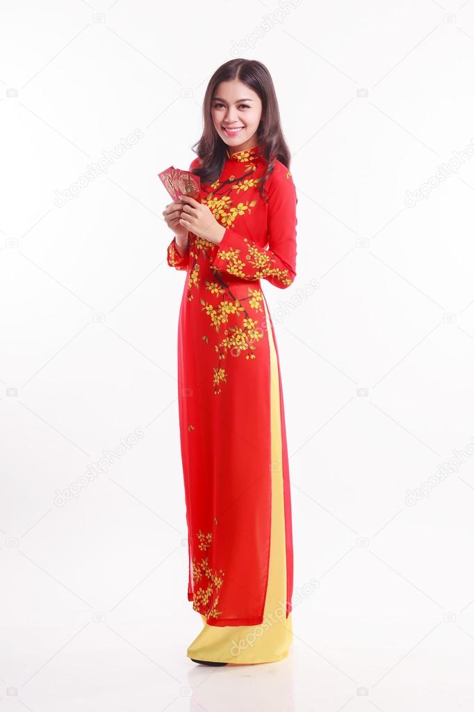 Beautiful Vietnamese woman with red ao dai holding lucky red packet for celebrate lunar new year