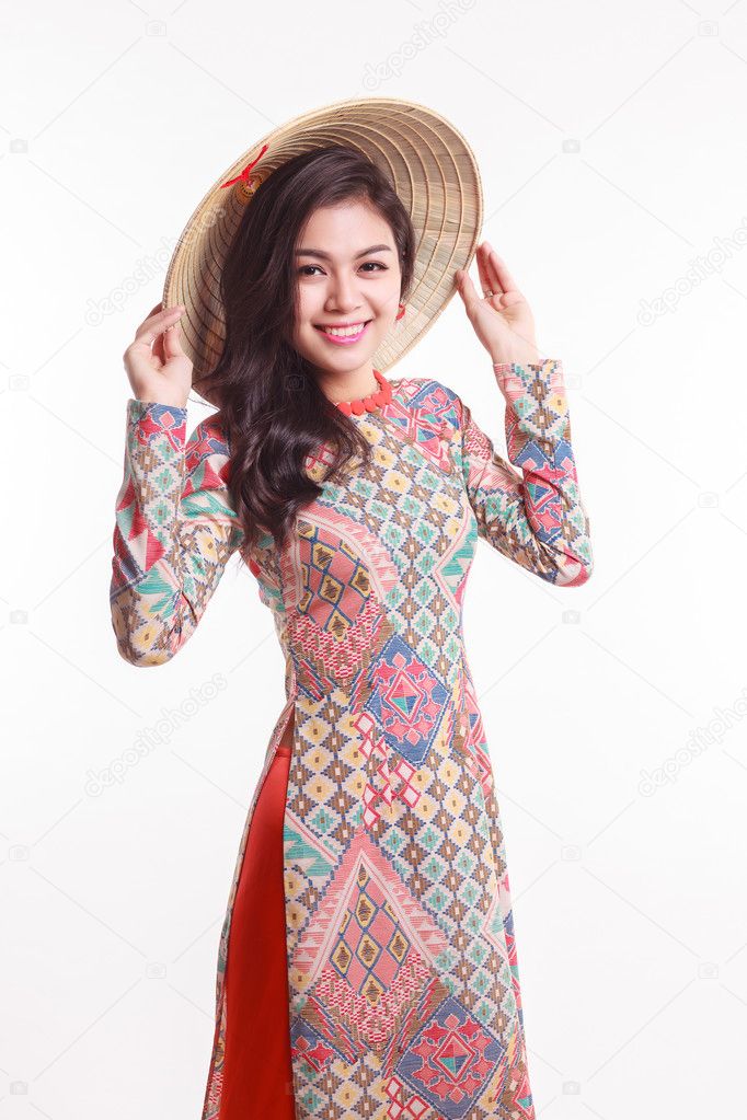 Beautiful Vietnamese young woman with tradition modern ao dai and palm-leaf conical hat