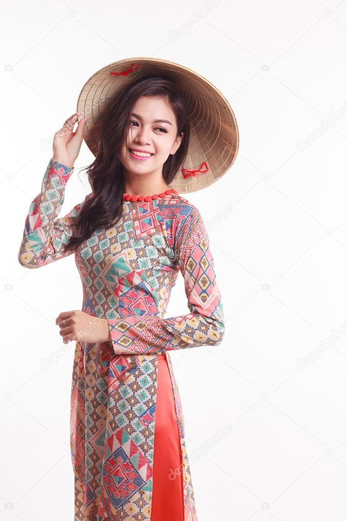 Beautiful Vietnamese young woman with tradition modern ao dai and palm-leaf conical hat