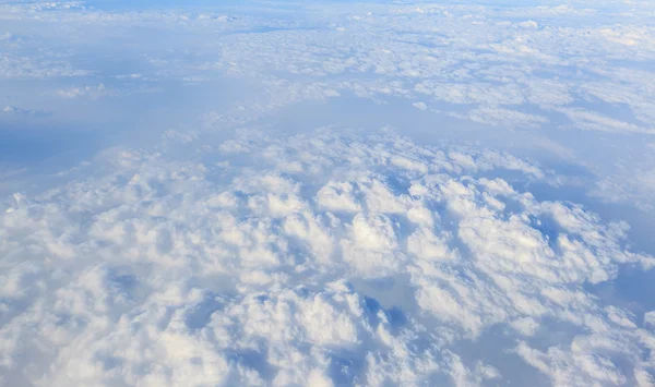 Blue sky and white cloud background from airplane window — Stock Photo, Image