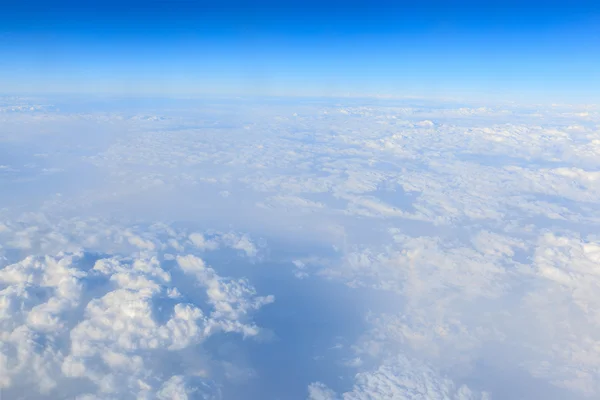 Blue sky and white cloud background from airplane window — Stock Photo, Image