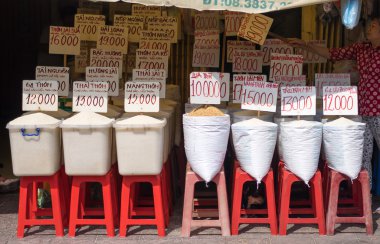 Different kinds of rice with name and price tag in rice shop at local market, Saigon, Vietnam