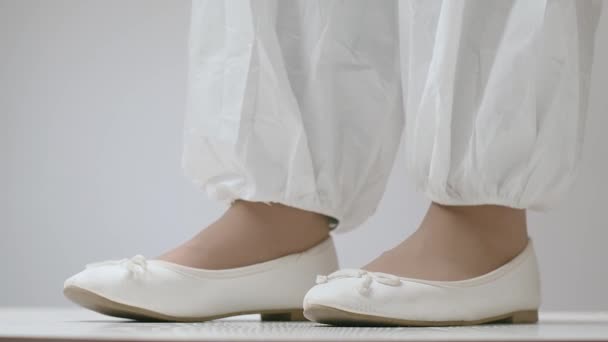 Mujer en traje de protección especial que se pone cubiertas de zapatos para mantener los virus y bacterias lejos de los patines en el hospital. — Vídeos de Stock