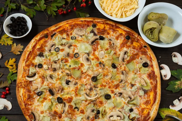 Enginar ve zeytinle taze pizza yaptım. Organik ürünlerle vejetaryen yemeği. Öğle yemeği için fast food, arka planda malzemeler..