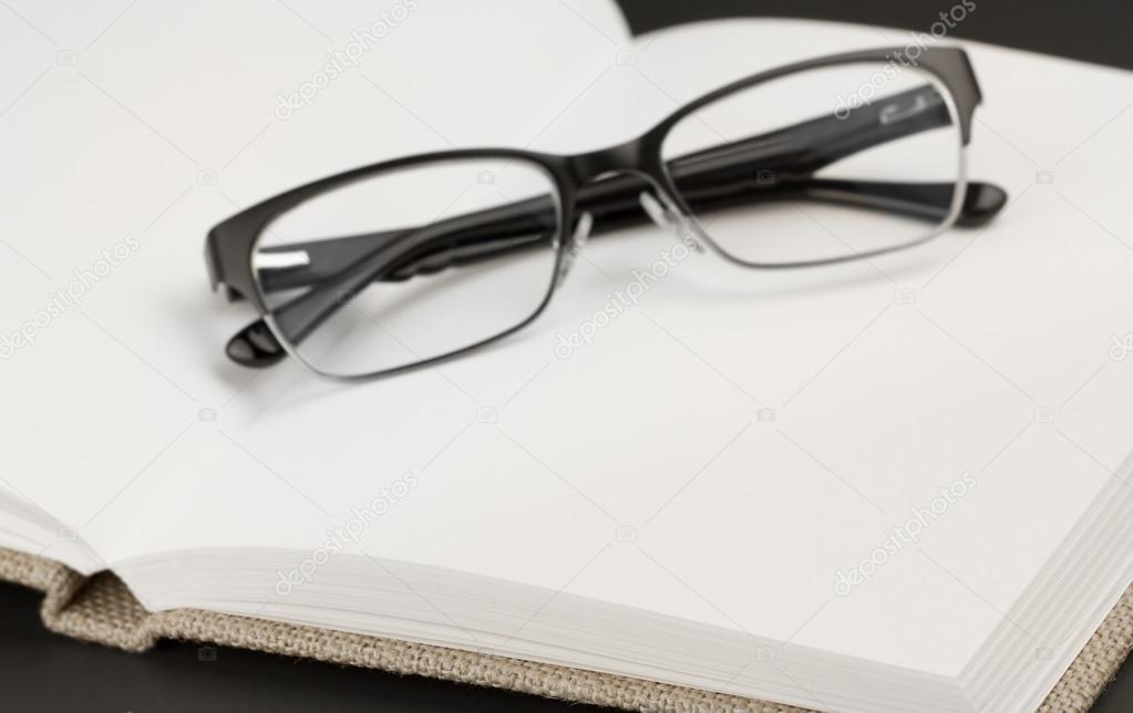 Black glasses on book