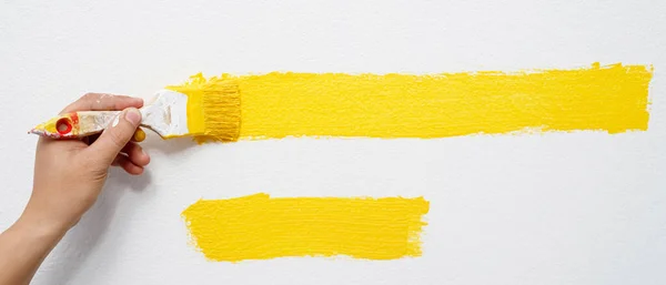 画家正在用黄色粉刷墙壁和客厅的内部 — 图库照片