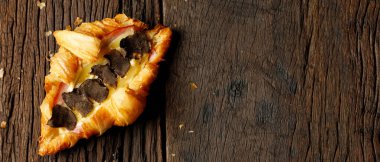 Kruvasan ekmeği ahşap bir masaya yerleştirilmiş.