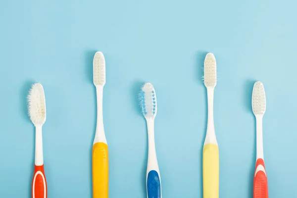 Old Toothbrush Used Expired Damaged Variety Colors Blue Background Concept — Stock Photo, Image