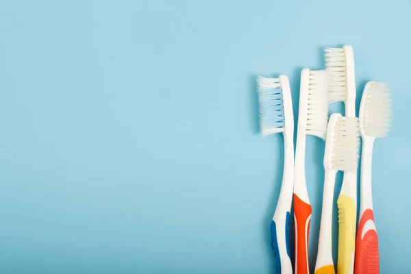 Old Toothbrush Used Expired Damaged Variety Colors Blue Background Concept — Stock Photo, Image