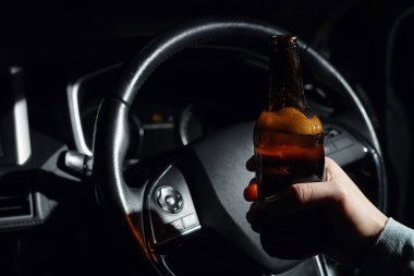 Drinking beer in a car is dangerous for drivers.