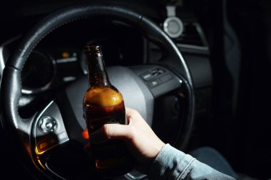 Drinking beer in a car is dangerous for drivers.
