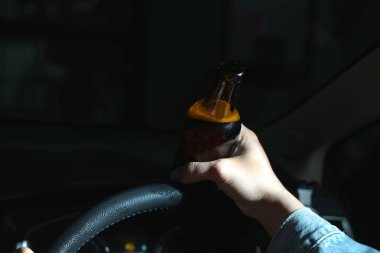 Drinking beer in a car is dangerous for drivers.