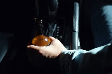 Drinking beer in a car is dangerous for drivers.
