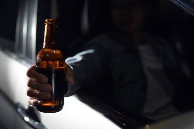 Drinking beer in a car is dangerous for drivers.