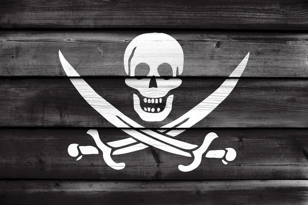 Bandera pirata Calico Jack, pintada sobre fondo de madera vieja — Foto de Stock