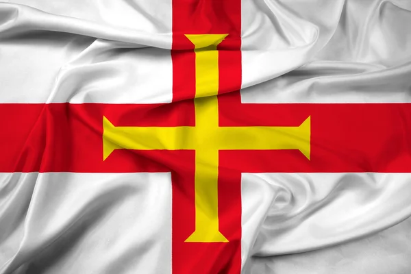 Flagge von Guernsey schwenkend — Stockfoto