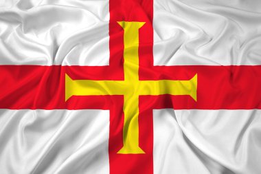 Guernsey bayrağı sallayarak